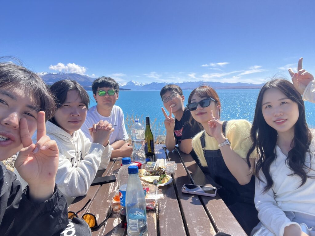 People taking selfie near lake Tekapo