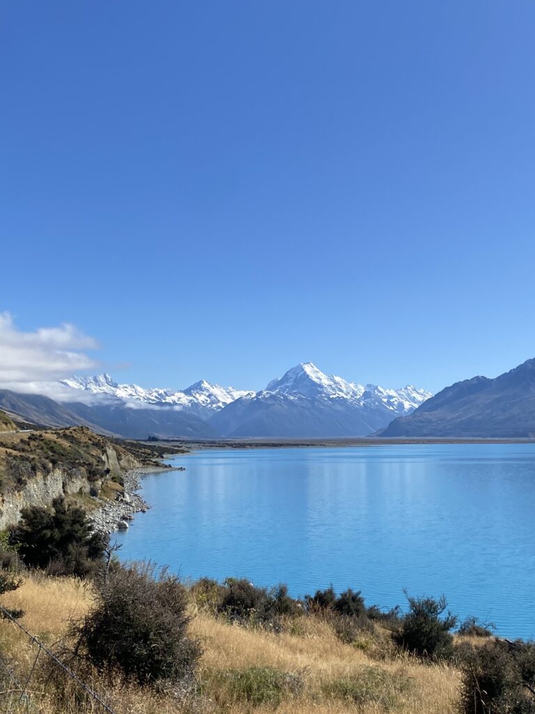 Mountain with glaciers and lake Pukaki in New Zealand which is one of best places to travel
