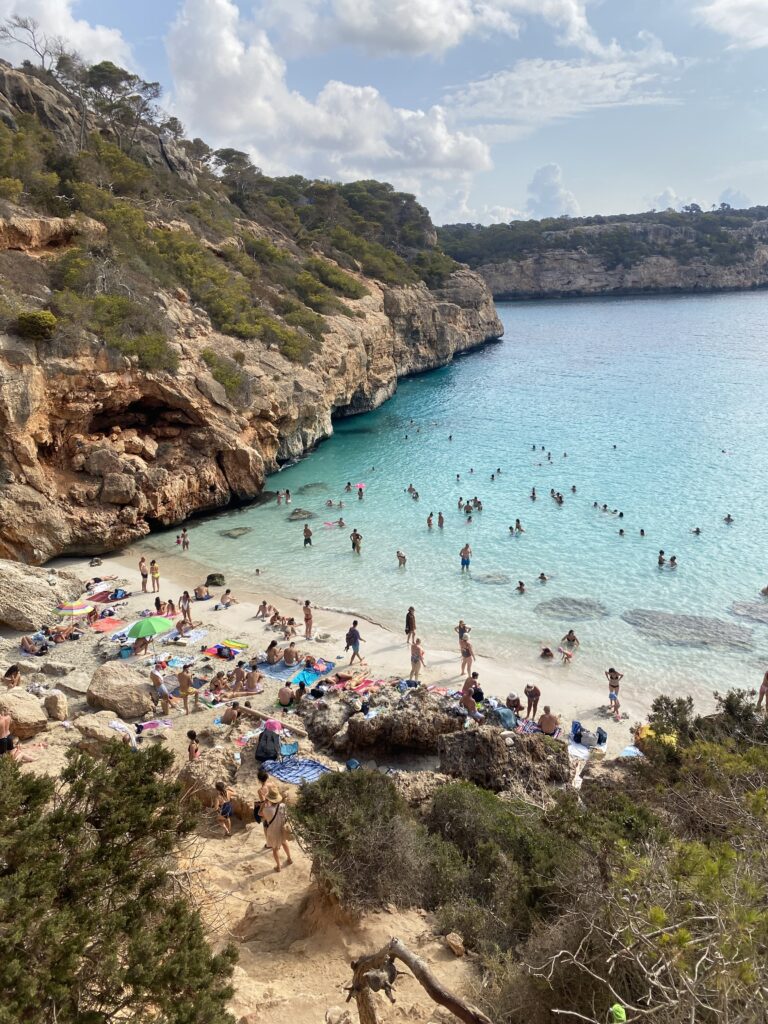 Beach named "Calo des Moro" in Mallorca and people are swimming in the beach